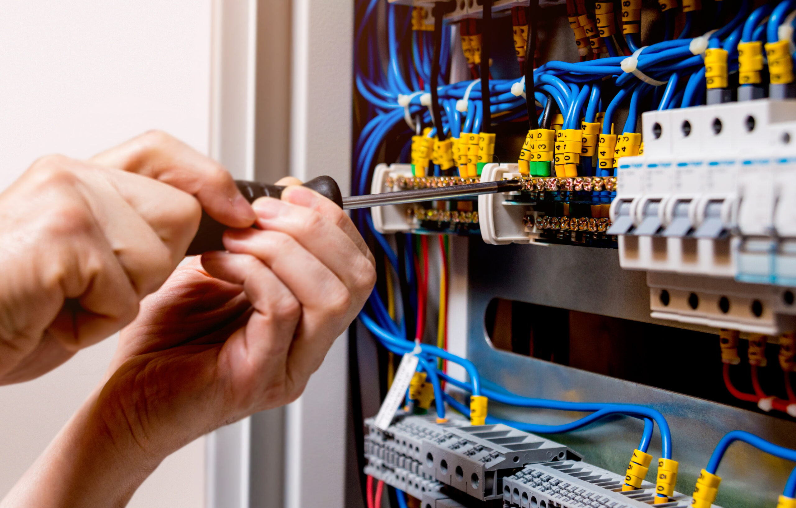 The man is repairing the switchboard voltage with automatic switches. Electrical background; Shutterstock ID 708218965; Purchase Order: -